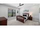 Comfortable bedroom with a wooden bed frame, ceiling fan, and view to the outside at 106 Beachview Dr, Mooresville, NC 28117