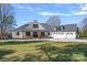 Stunning white modern farmhouse featuring a three car garage and a welcoming front porch at 106 Beachview Dr, Mooresville, NC 28117
