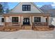 Inviting home exterior showcasing a brick porch with exposed wood and glass front doors at 106 Beachview Dr, Mooresville, NC 28117