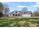 Charming white farmhouse with a three-car garage and a sprawling, green front yard at 106 Beachview Dr, Mooresville, NC 28117