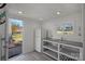 Convenient kitchenette in the boat house featuring a sink, countertop, and a refrigerator at 106 Beachview Dr, Mooresville, NC 28117