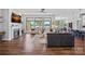 Spacious living room featuring a fireplace, hardwood floors, and a wall of windows showcasing lake views at 106 Beachview Dr, Mooresville, NC 28117