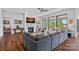 Comfortable living room with a fireplace, hardwood floors, and large windows overlooking the lake and yard at 106 Beachview Dr, Mooresville, NC 28117