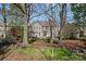 Private backyard offering mature trees, a stone fire pit, and patio, perfect for relaxation and outdoor enjoyment at 10823 Caverly Ct, Huntersville, NC 28078