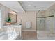 Bright and airy bathroom with a tiled shower, garden tub, and dual vanities at 10823 Caverly Ct, Huntersville, NC 28078