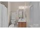 Neutral toned bathroom with a single sink vanity and visible toilet at 10823 Caverly Ct, Huntersville, NC 28078