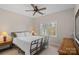 Bright bedroom featuring a metal bed frame, ceiling fan, and natural light from a window at 10823 Caverly Ct, Huntersville, NC 28078