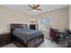 Cozy bedroom features a large bed, ceiling fan, and natural light from window with a view at 10823 Caverly Ct, Huntersville, NC 28078