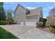 Spacious three car garage with an extended driveway and manicured landscaping at 10823 Caverly Ct, Huntersville, NC 28078