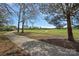 Scenic view of the golf course, with a paved path and mature trees in the foreground at 10823 Caverly Ct, Huntersville, NC 28078