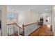 Spacious upstairs hallway with hardwood floors, and wrought iron railing and trim at 10823 Caverly Ct, Huntersville, NC 28078