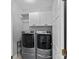Modern laundry room with washer, dryer, and white cabinets at 10823 Caverly Ct, Huntersville, NC 28078