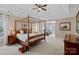 Spacious primary bedroom featuring a four-poster bed and a sitting area at 10823 Caverly Ct, Huntersville, NC 28078
