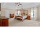 Spacious bedroom featuring a four-poster bed, tray ceilings, and abundant natural light at 10823 Caverly Ct, Huntersville, NC 28078
