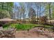 Outdoor patio features a fire pit, seating, and an umbrella table in a verdant setting at 10823 Caverly Ct, Huntersville, NC 28078