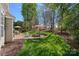 Outdoor patio features a fire pit, seating, and an umbrella table in a well-manicured yard at 10823 Caverly Ct, Huntersville, NC 28078
