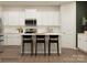 Bright kitchen featuring stainless steel appliances, a kitchen island, and white cabinetry at 109 Dogwood Grove Pl, Troutman, NC 28166