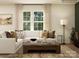 Comfortable living room featuring a white sofa, decorative pillows, and a stylish coffee table at 109 Dogwood Grove Pl, Troutman, NC 28166