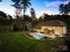 Expansive backyard featuring a sparkling pool, a screened-in porch, and mature trees at 113 Sandy Cove Ct, Mooresville, NC 28117
