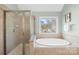 Bright bathroom featuring a glass shower and separate garden tub at 113 Sandy Cove Ct, Mooresville, NC 28117