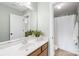 Bright bathroom features a sink, vanity with drawers, a well-lit mirror, and a shower with a white curtain at 113 Sandy Cove Ct, Mooresville, NC 28117