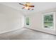 Carpeted bedroom with natural light, ceiling fan and backyard view at 113 Sandy Cove Ct, Mooresville, NC 28117