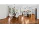 Sunlit dining area features hardwood floors and access to modern kitchen at 113 Sandy Cove Ct, Mooresville, NC 28117