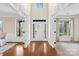 Grand foyer with hardwood floors, high ceilings, white trim, and transom windows at 113 Sandy Cove Ct, Mooresville, NC 28117