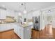 Open kitchen features white cabinets, granite countertops, and stainless appliances at 113 Sandy Cove Ct, Mooresville, NC 28117