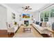 Bright living room with hardwood floors, a fireplace, built-ins, and large windows at 113 Sandy Cove Ct, Mooresville, NC 28117