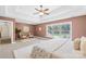 Bright primary bedroom with a cozy seating area and scenic backyard view at 113 Sandy Cove Ct, Mooresville, NC 28117