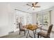 Bright home office with a ceiling fan, large window, and double doors leading to the entryway at 113 Sandy Cove Ct, Mooresville, NC 28117