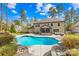 Inviting backyard pool with a stone surround, hot tub, screened porch, and lush landscaping at 113 Sandy Cove Ct, Mooresville, NC 28117