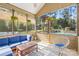 Inviting screened-in porch with comfortable seating and a view of the backyard pool at 113 Sandy Cove Ct, Mooresville, NC 28117