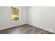 The bedroom has light gray wood-look flooring and a window with a view of trees and a deck at 1173 Yorkdale Ln, Lincolnton, NC 28092