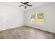 Bright bedroom with modern ceiling fan, two windows, and light wood flooring at 1173 Yorkdale Ln, Lincolnton, NC 28092