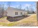 Well-maintained home exterior featuring light siding, a well-manicured lawn, and a cozy deck at 1173 Yorkdale Ln, Lincolnton, NC 28092