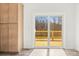View from inside to wooden deck through glass patio doors, next to cabinets in a room with light-colored walls at 1173 Yorkdale Ln, Lincolnton, NC 28092