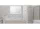 Bright bathroom with a soaking tub and a separate shower, offering a spa-like experience in the comfort of your home at 1207 Overhill Rd, Salisbury, NC 28144