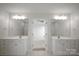 Bathroom with double vanity, white cabinetry, and a view into another room at 1207 Overhill Rd, Salisbury, NC 28144