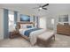 Staged bedroom featuring a ceiling fan, bedside tables and lamps, and a bench at the end of the bed at 1207 Overhill Rd, Salisbury, NC 28144