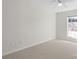 Empty bedroom with neutral carpet, ceiling fan, and a window that lets in ample natural light at 1207 Overhill Rd, Salisbury, NC 28144