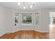 Bright dining area with hardwood floors, large windows, and modern chandelier, perfect for Gathering meals at 1207 Overhill Rd, Salisbury, NC 28144