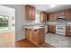 Charming kitchen with oak cabinets, breakfast bar, stainless steel appliances, and tile flooring at 1207 Overhill Rd, Salisbury, NC 28144