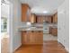 Traditional-style kitchen with oak cabinets, breakfast bar, modern appliances and access to the living room at 1207 Overhill Rd, Salisbury, NC 28144