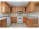 Well-lit kitchen featuring oak cabinets, light countertops, and white appliances, perfect for cooking at 1207 Overhill Rd, Salisbury, NC 28144
