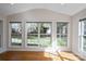 Bright living room featuring hardwood floors and large windows offering ample natural light and backyard views at 1207 Overhill Rd, Salisbury, NC 28144