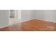 Bright living room with gleaming hardwood floors and doorway access to carpeted hallway at 1207 Overhill Rd, Salisbury, NC 28144