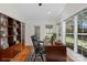 Home office featuring a built-in bookcase, a dark wood desk and chair, and a window with natural light at 1207 Overhill Rd, Salisbury, NC 28144