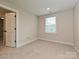 Bedroom featuring view into bath, bright window, neutral paint and carpet at 1324 Sage Pine Cir, Clover, SC 29710